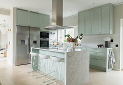 Kitchen in marble and mint green with cooking island