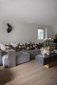 Grey sofa set with cushions and coffee table in light living room