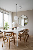 Light-flooded dining area with white table and classic chairs