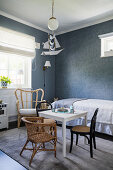 Children's room in blue-grey tones, with various seating furniture