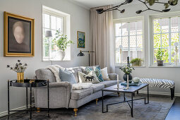 Cozy upholstered sofa in living room in shades of grey