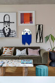 Sitzbereich mit Sofa, darüber moderne Kunstwerke in offenem Wohnraum
