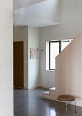 Hallway with terrazzo floor and wooden staircase