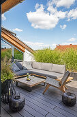 Outdoor-Sitzmöbel und Bodenlaternen auf Dachterrasse