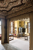 Decorative interior canopy of four postered bed 17th century flame stitch embroidery with oriental lacquered cabinet