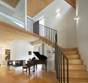 Living area with grand piano and stairway