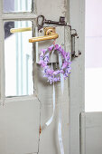 Wreath of purple hyacinth flowers on an old door handle