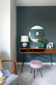 Dressing table and stool with velvet upholstery with round mirror on the wall