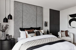 Modern bedroom in neutral tones, full length upholstered headboard