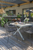 Terrace with wooden floor and modern patio furniture