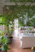 Lounge with overflowing with green houseplants