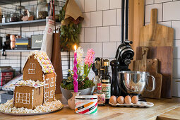 Selbst gemachtes Lebkuchenhaus auf einer Arbeitsplatte in der Küche