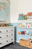 Children's room with world map, chest of drawers, bookshelf and toy box
