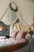 Cozy bedroom with airy bed canopy