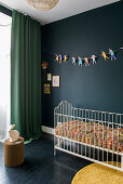 Kinderzimmer mit dunkler Wand und farbenfroher Dekoration