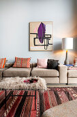 Coffee table on colorful rug and upholstered sofa in the living room