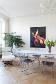 Bright dining area with modern art and designer chairs