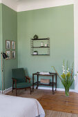 Sitting area in the bedroom with green walls