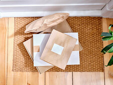 Delivered cardboard boxes on a doormat at the entrance to home