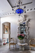 Baroque mirror with carvings and bespoke chandelier in London townhouse
