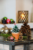 Mini tree made from painted pine cones with wooden star
