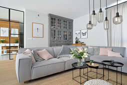 Grey corner sofa and glass pendant lights in the modern living room