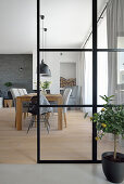 Modern dining room with glass wall and lemon tree in a pot