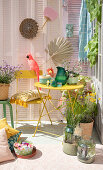 Balcony with summer decorations, colourful furniture and various plants