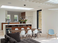 Open-plan living area with kitchen island and dining table, London