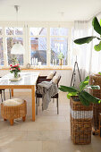 Conservatory dining room with stool, sheepskin and banana plants