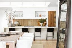 Bright cooking and dining area with wood and natural stone accents