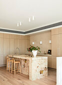 Modern kitchen with marble island and light-coloured wooden fronts