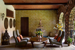 Covered seating area with fountain and patterned tiled walls