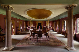 Dining room with granite columns and sumptuous colonial-style carpet
