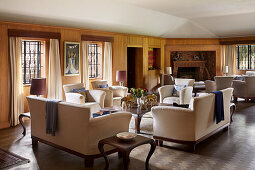 Wood-panelled living room with upholstered furniture and fireplace