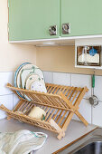 Wooden crockery rack with vintage crockery in a 1940s kitchen