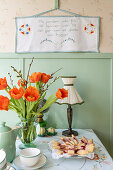 Table with red tulips (Tulipa) in 40s kitchen style