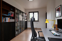 Home office with black desk chair and bookshelf