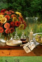Buffet table with crockery, salad and flowers in open air
