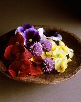 Edible flowers on a wooden plate