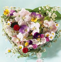 Heart of horned violets, roses, lilies of the valley, chamomile