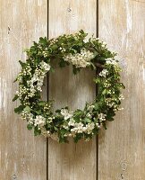 Hawthorn wreath hanging on a wooden wall