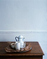 Glasses, a jug and a bowl on a tray