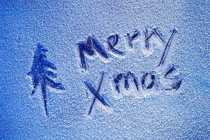 Merry Xmas written on sheet of ice