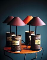 Small table lamps in old medicine cans