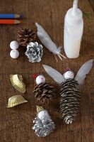 Christmas craft material – pine cones, feathers, glue and balls
