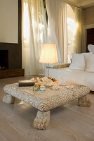 Wooden coffee table with carvings and shell decoration in the living room