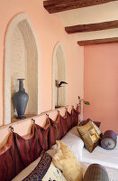 Bedroom with wall niches and textiles in warm colours