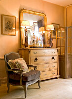 Antique chest of drawers with mirror, armchair with cushions