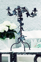 Candlestick with leaf motif on a garden table